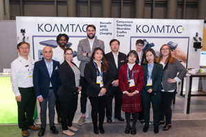 KOAMTAC team in front of booth at NRF 2020